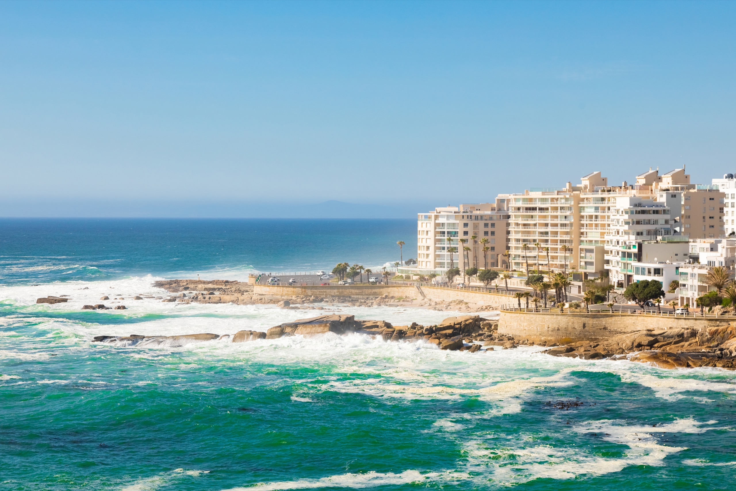 Residences overlooking a rocky coastline and the Pacific Ocean