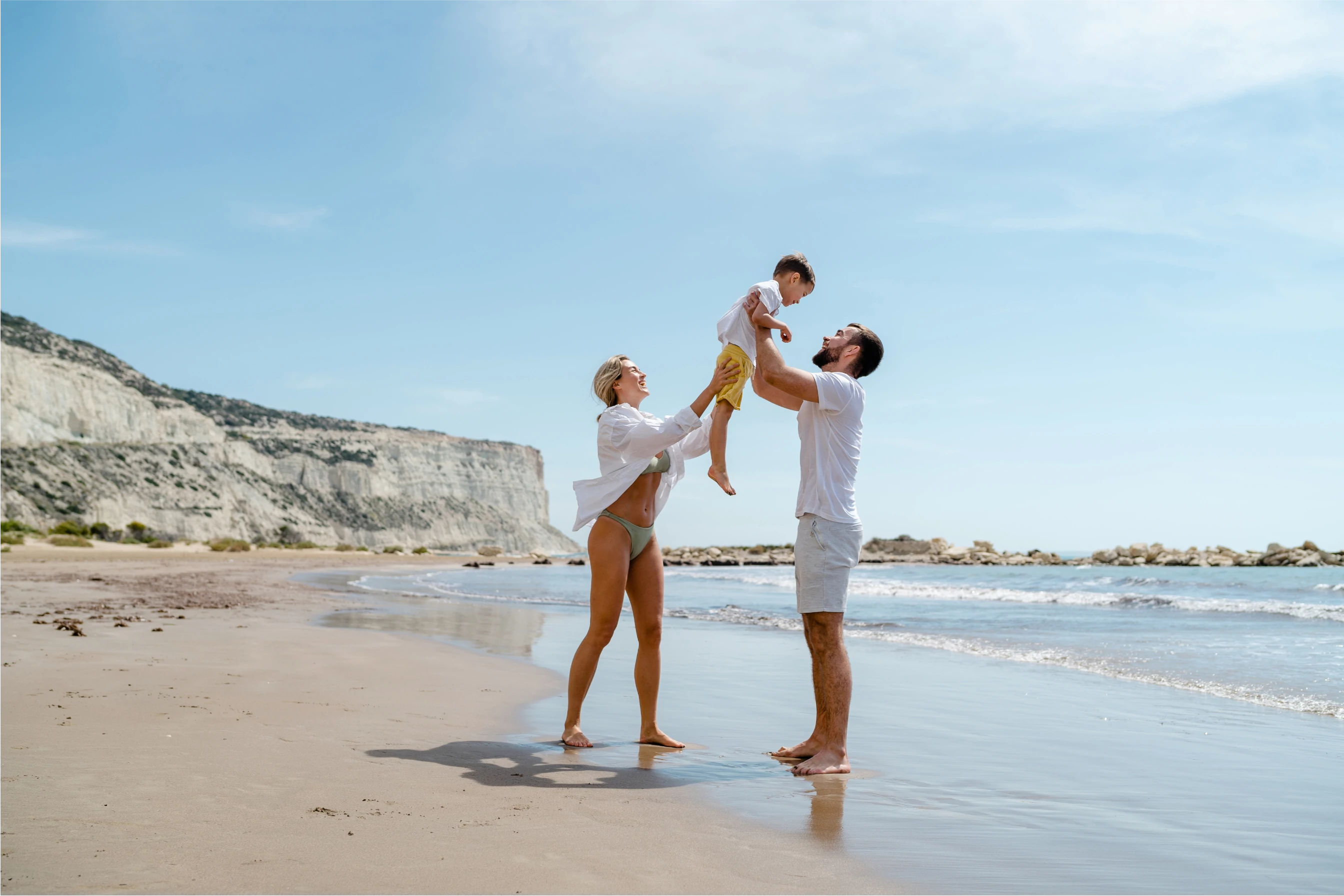 Family playing together on a beach vacation